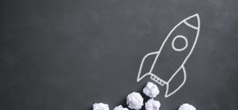 Space rocket on blackboard